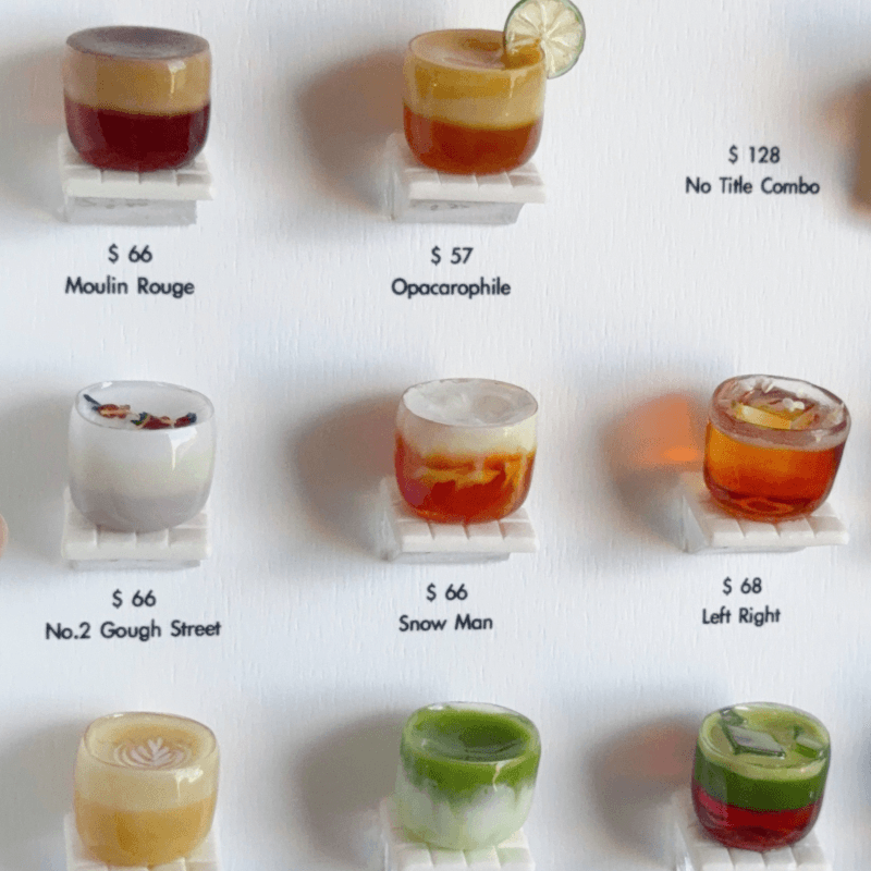 Miniature cocktail sculptures arranged like a restaurant menu board