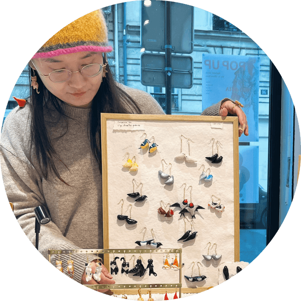 Yao Lin, the artist behind Bada & Mimo, holding a tray of miniature jewellery