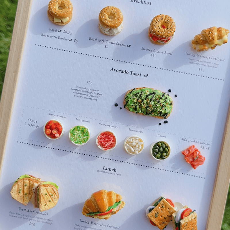 Miniature bakery-inspired menu board displayed at TÊTE-À-TÊTE Cafeteria, USA